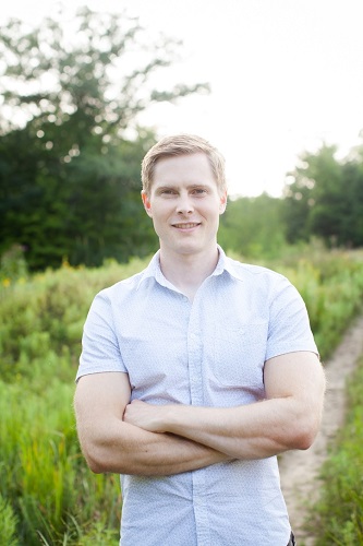 Dr. Brian Hill, DDS, standing outdoors with his arms crossed
