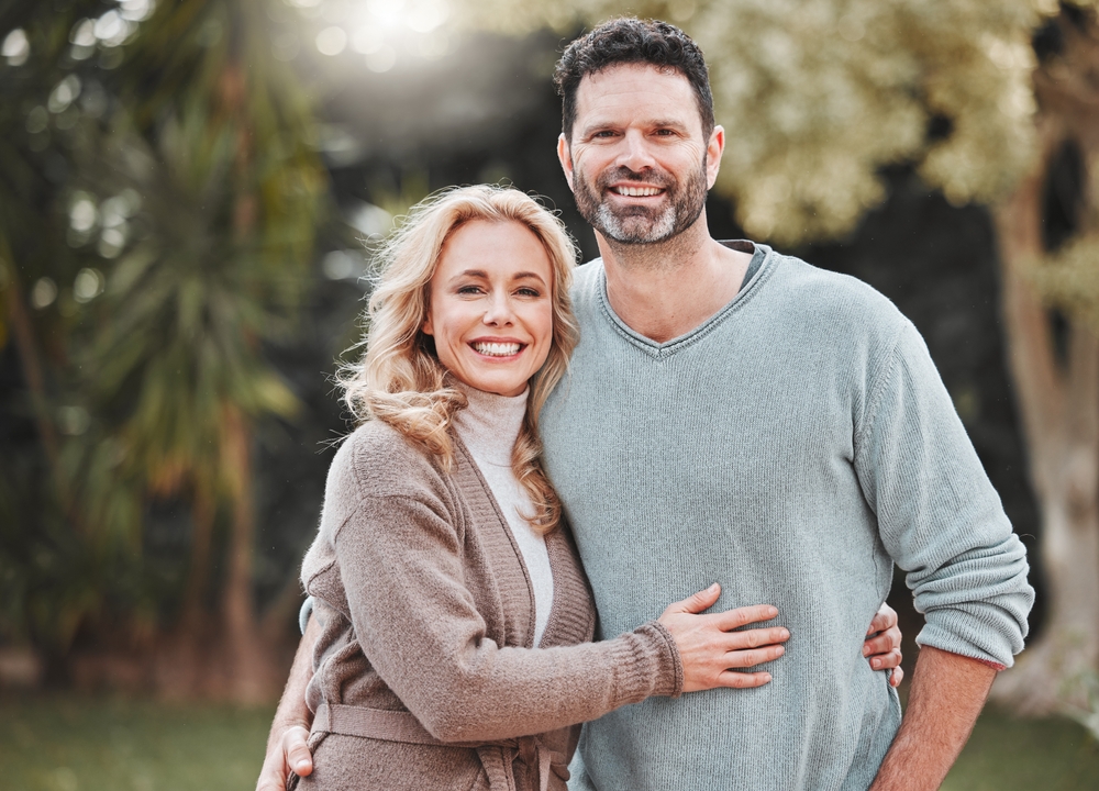 Smiling couple standing together outdoors